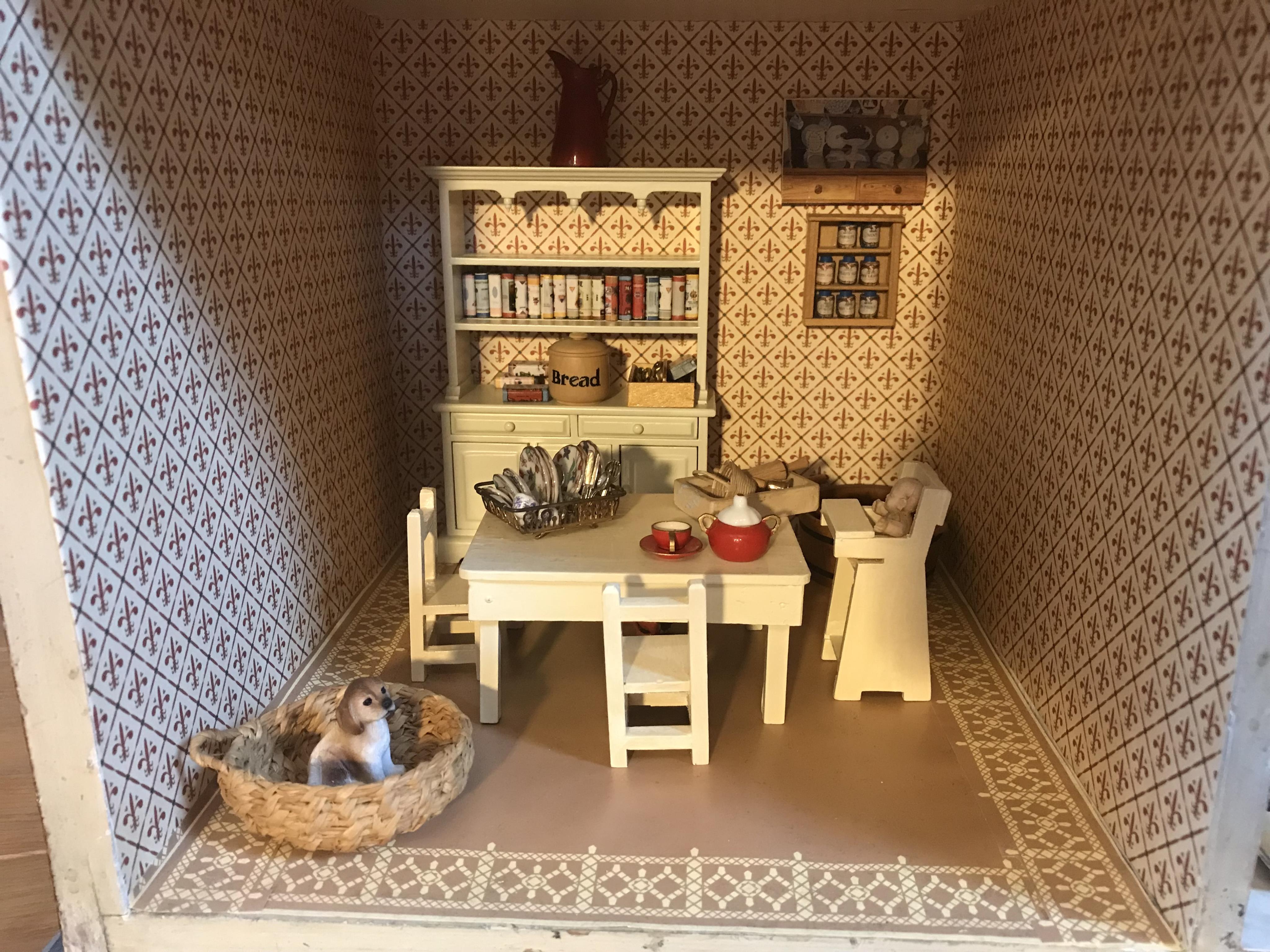 A late 19th century doll's house, with a single front opening panel, incorporating eight internal rooms, flat roof with parapet, dimensions 81.5cm high, 79cm wide, 30cm deep, together with modern manufactured furniture a